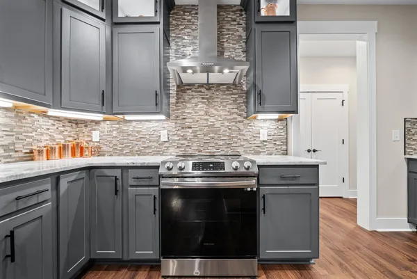 a kitchen with a refrigerator and a stove