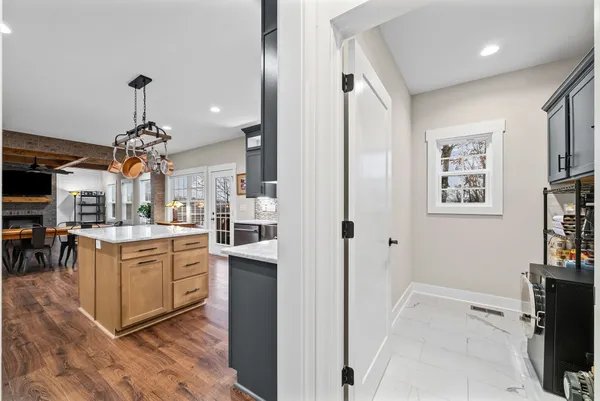 a view of an empty room with bookshelf and a wooden floor