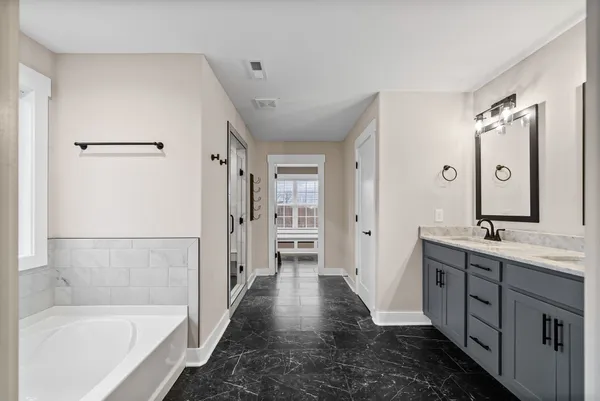 a bathroom with double sink and a mirror