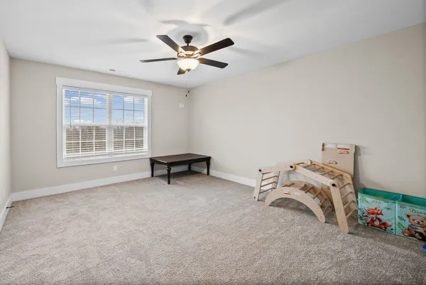 a view of a livingroom with furniture and a ceiling fan
