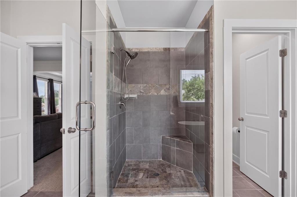 139 Manchester Lane Villa Rica, GA 30180 - Photo 34 of 60 a bathroom with a glass shower door