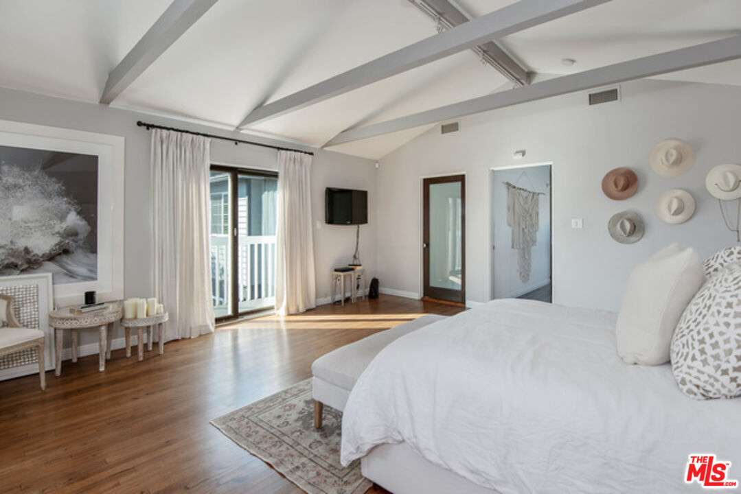 426 Venice Way Venice, CA 90291 - Photo 13 of 21 a bedroom with a bed and a wooden floor