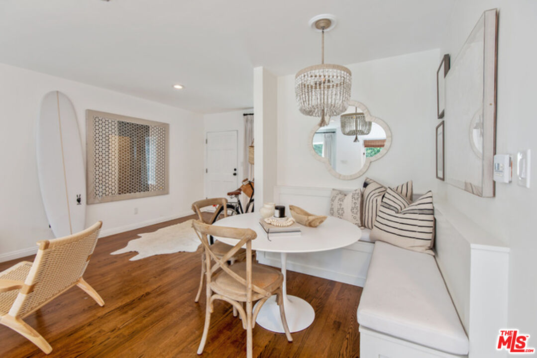 426 Venice Way Venice, CA 90291 - Photo 5 of 21 a dining room with wooden floor a chandelier a wooden table and chairs