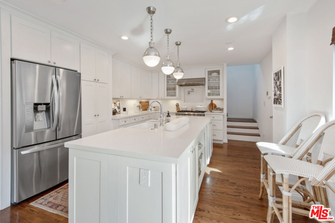 426 Venice Way Venice, CA 90291 - Photo 9 of 21 a kitchen with counter top space stainless steel appliances and wooden floor