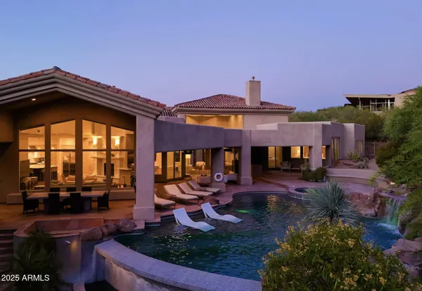 a view of a house with backyard porch and sitting area