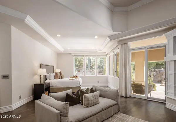 a bedroom with a bed and a large window