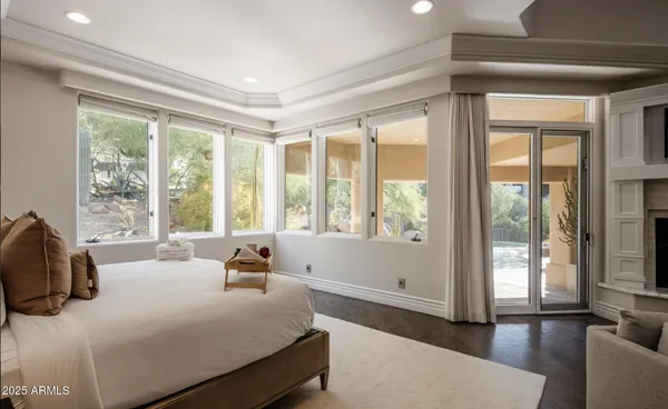 a bedroom with a bed and a large window