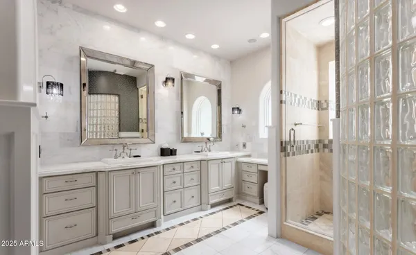 a bathroom with double sink and a mirror