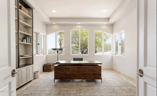 a bedroom with a bed a dresser and a window