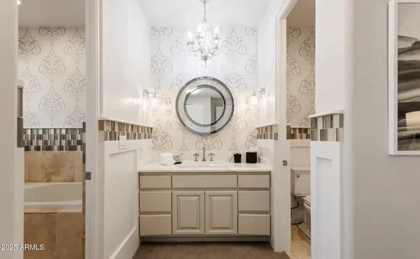 a bedroom with a bed lamp and a large window