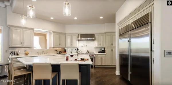 a kitchen with stainless steel appliances a sink a stove and cabinets