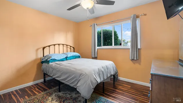 a bedroom with a bed a window and a chandelier