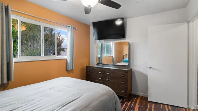 a bedroom with a bed and a flat screen tv