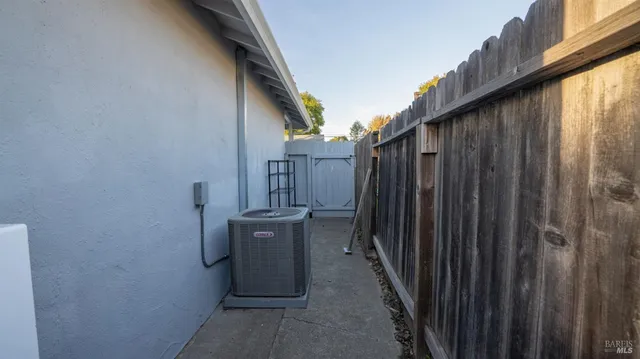 a view of a house with backyard and wooden fence