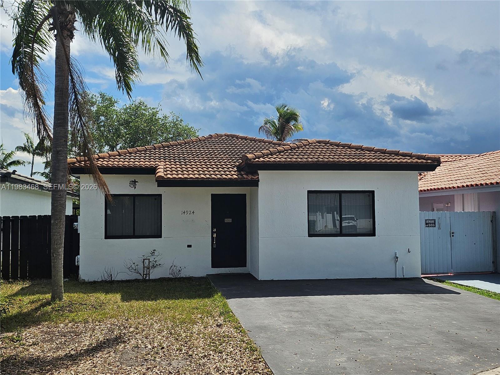 14924 Southwest 58th Street Miami, FL 33193 - Photo 1 of 17 a front view of a house with a yard