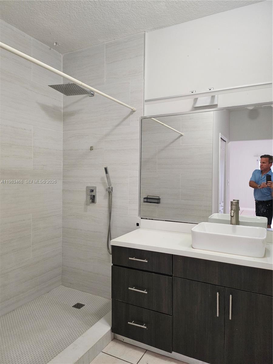14924 Southwest 58th Street Miami, FL 33193 - Photo 13 of 17 a bathroom with a shower sink vanity and mirror