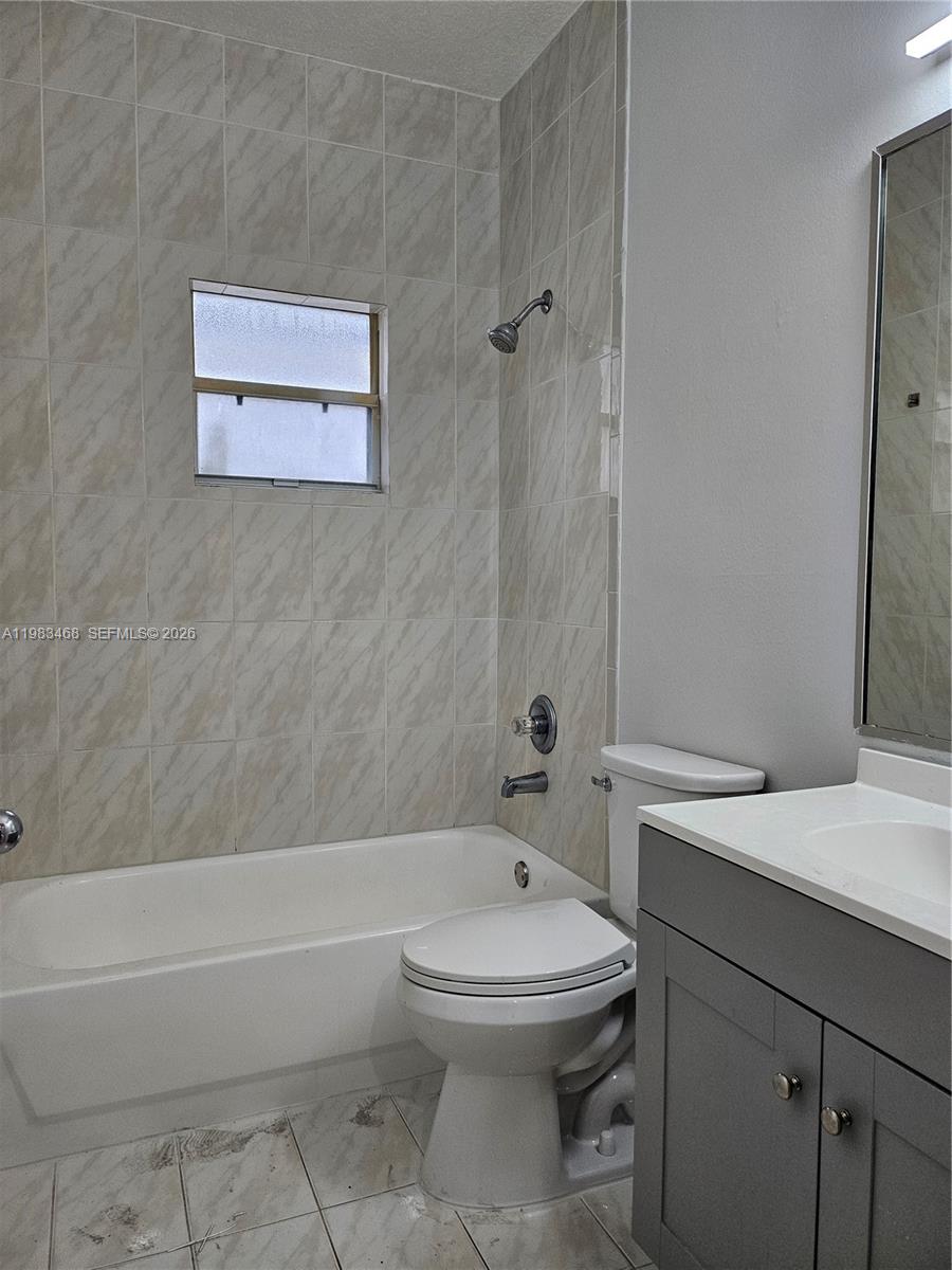 14924 Southwest 58th Street Miami, FL 33193 - Photo 9 of 17 a bathroom with a sink a toilet and shower