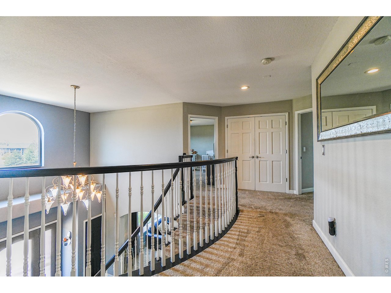 3938 Vale View Lane Mead, CO 80542 - Photo 19 of 49 a view of a hallway with wooden floor