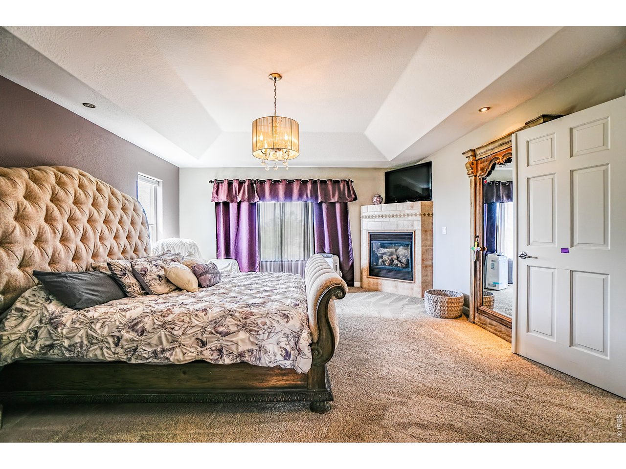 3938 Vale View Lane Mead, CO 80542 - Photo 22 of 49 a bedroom with a bed window and a fireplace