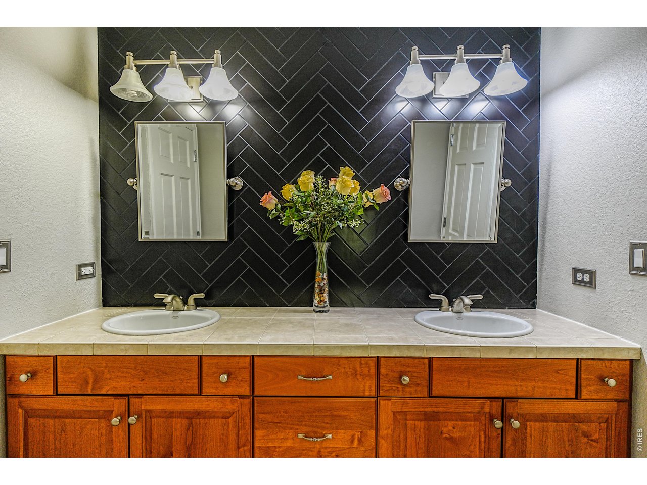 3938 Vale View Lane Mead, CO 80542 - Photo 27 of 49 a bathroom with a sink and a mirror