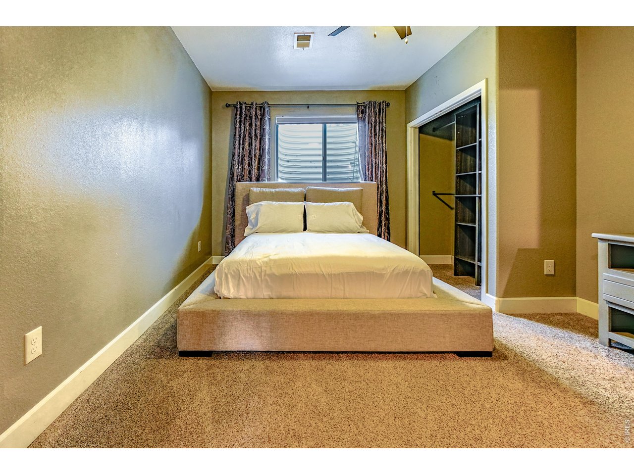 3938 Vale View Lane Mead, CO 80542 - Photo 34 of 49 a spacious bedroom with a bed and a dresser
