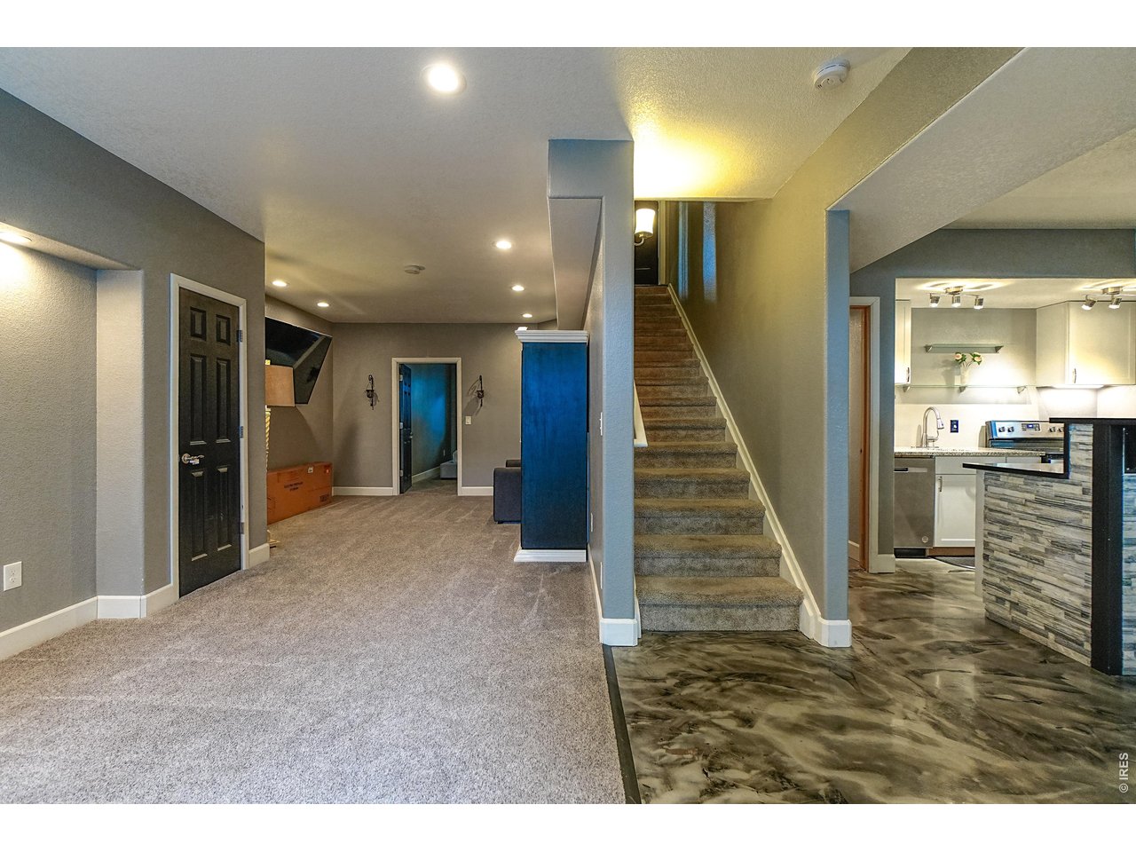 3938 Vale View Lane Mead, CO 80542 - Photo 37 of 49 a view of a hallway with wooden floor and staircase
