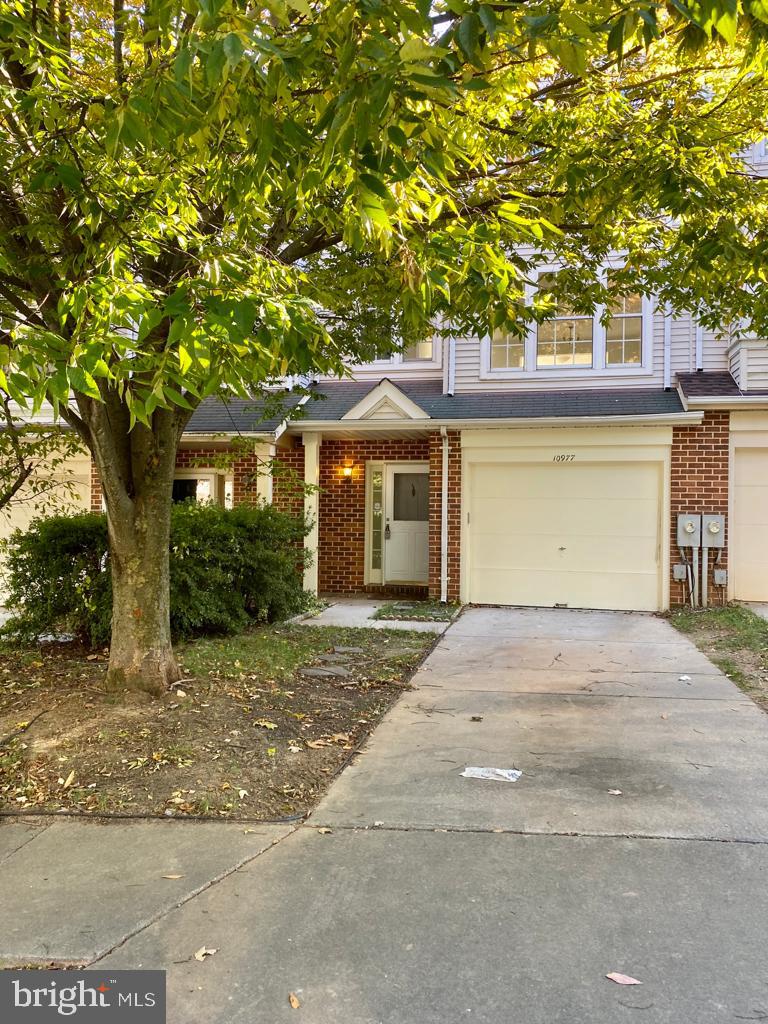 10977 Baskerville Road Reisterstown, MD 21136 - Photo 1 of 13 a front view of a house with a garden