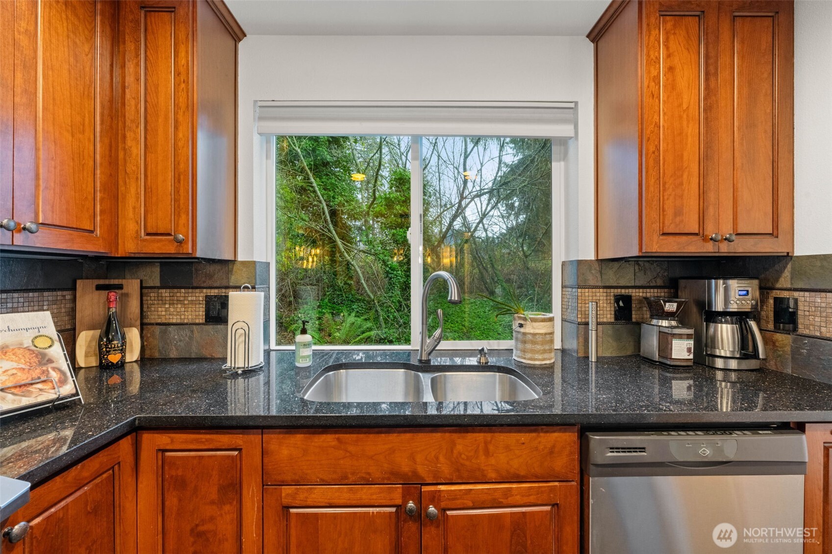 14714 53rd Avenue West, Unit 104 Edmonds, WA 98026 - Photo 13 of 35 a kitchen with granite countertop a window a sink and cabinets