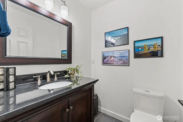 a bathroom with a toilet a sink and mirror