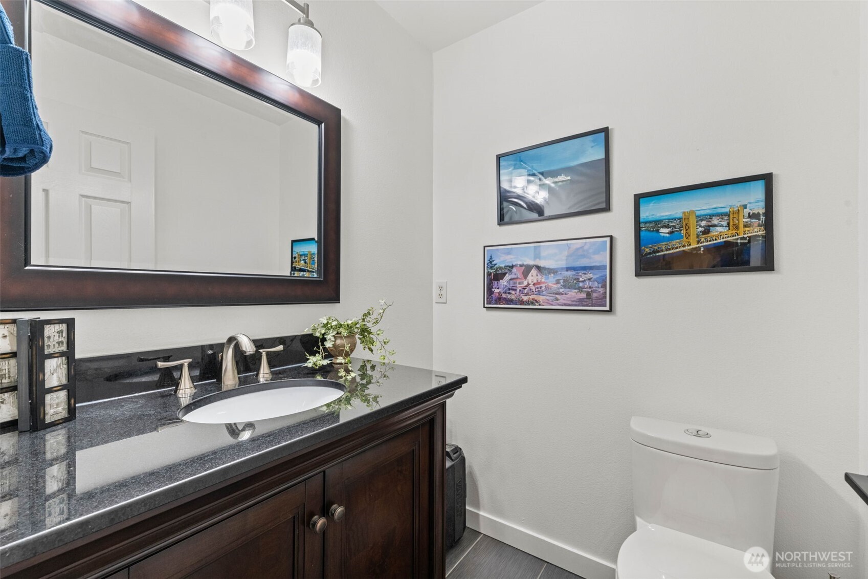 14714 53rd Avenue West, Unit 104 Edmonds, WA 98026 - Photo 15 of 35 a bathroom with a toilet a sink and mirror