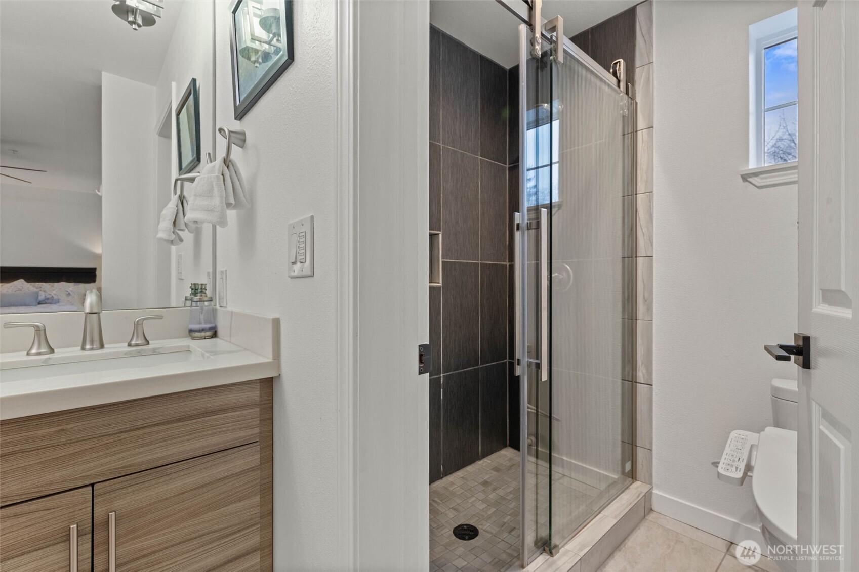 14714 53rd Avenue West, Unit 104 Edmonds, WA 98026 - Photo 29 of 35 a bathroom with a shower sink and toilet