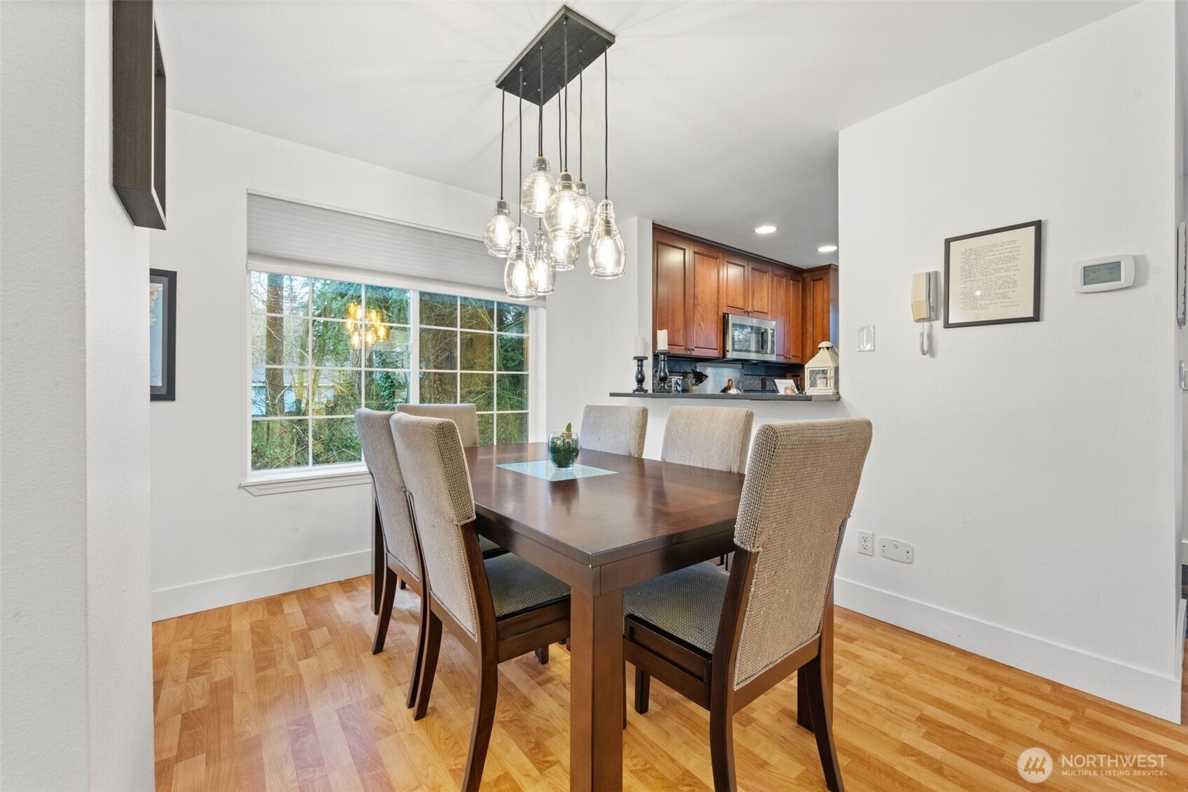 14714 53rd Avenue West, Unit 104 Edmonds, WA 98026 - Photo 7 of 35 a dining room with furniture a chandelier and wooden floor