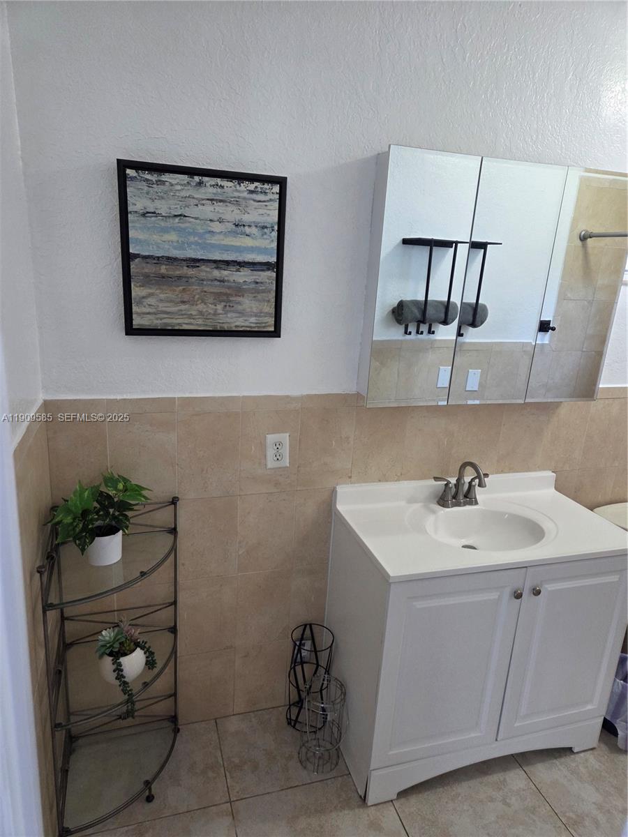 2972 Northwest 15th Street, Unit 2 Miami, FL 33125 - Photo 13 of 17 a bathroom with a sink and a mirror