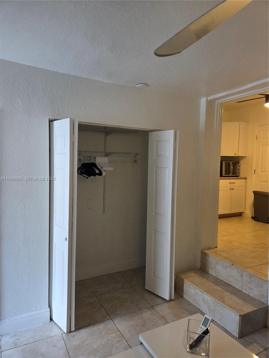 2972 Northwest 15th Street, Unit 2 Miami, FL 33125 - Photo 14 of 17 a view of a hallway with bathroom and wooden floor