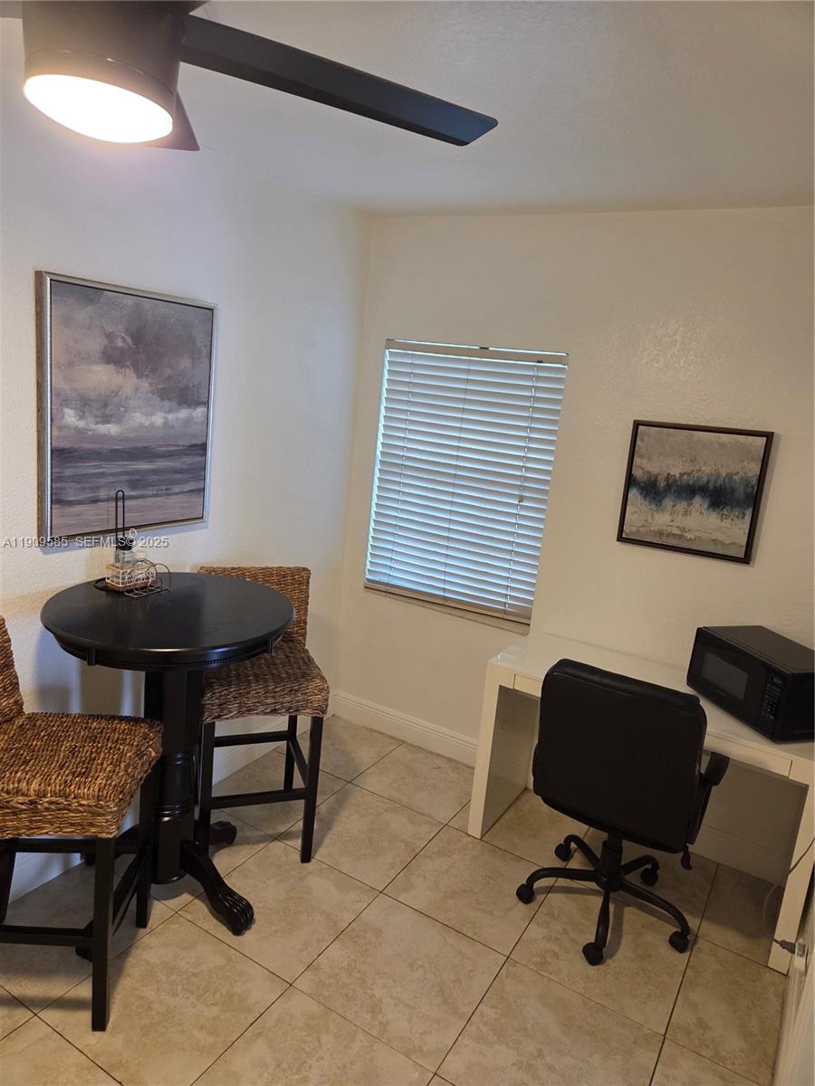 2972 Northwest 15th Street, Unit 2 Miami, FL 33125 - Photo 15 of 17 a view of a livingroom with workspace and a couch