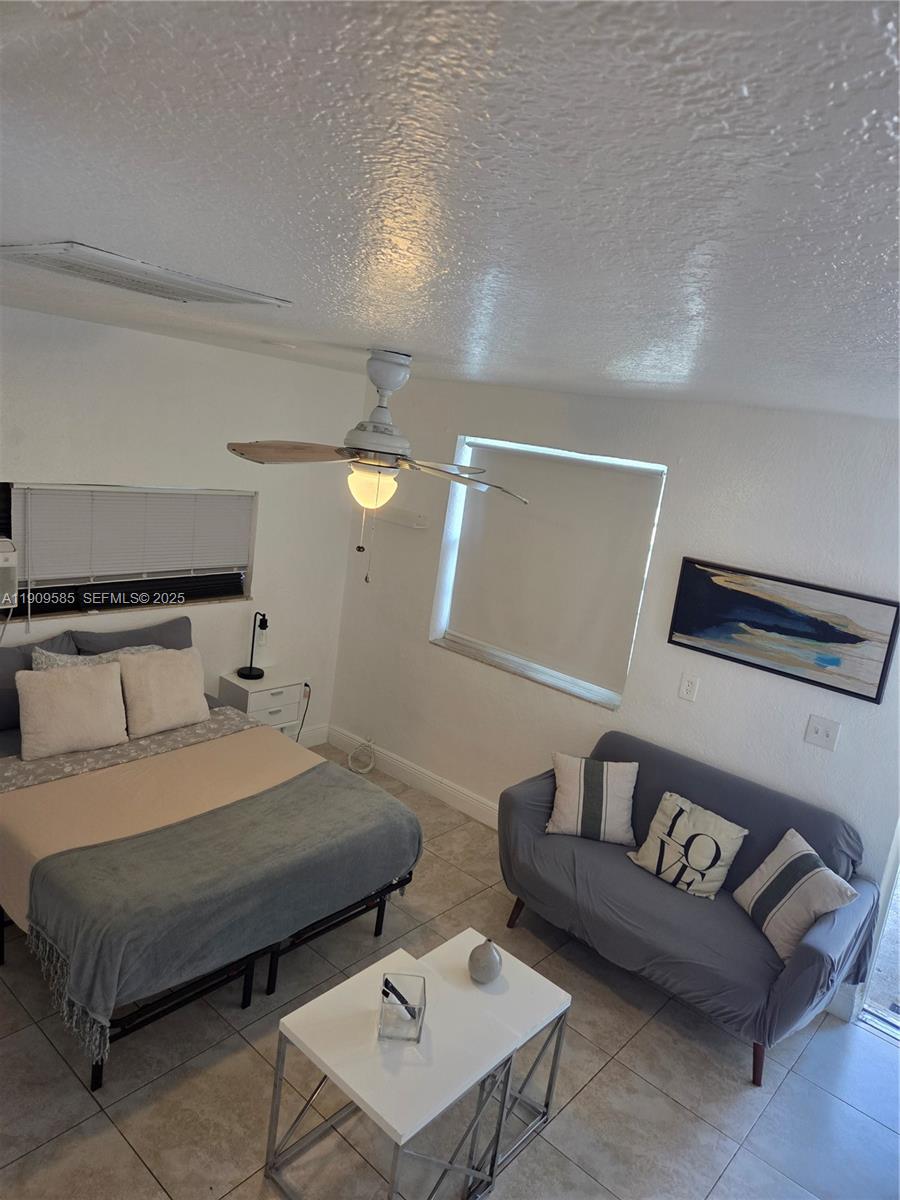 2972 Northwest 15th Street, Unit 2 Miami, FL 33125 - Photo 17 of 17 a bedroom with a bed and a couch