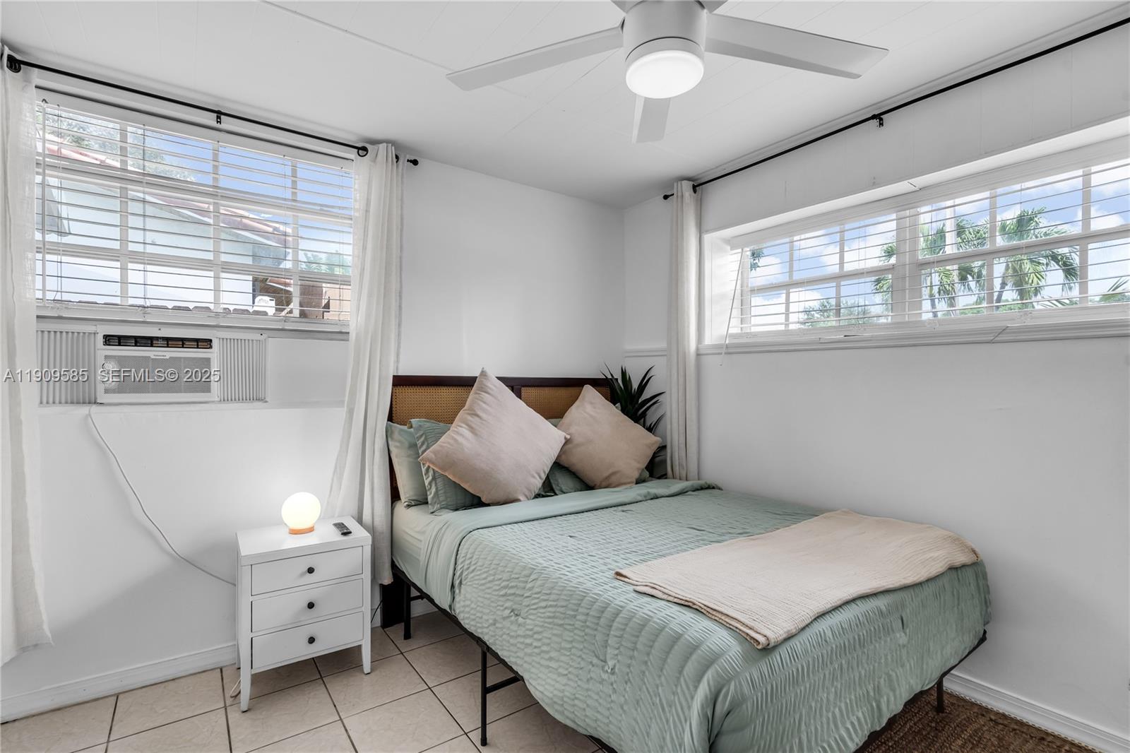 2972 Northwest 15th Street, Unit 2 Miami, FL 33125 - Photo 3 of 17 a bedroom with a large bed and a large window