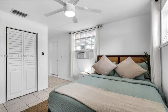 a bedroom with a bed and window