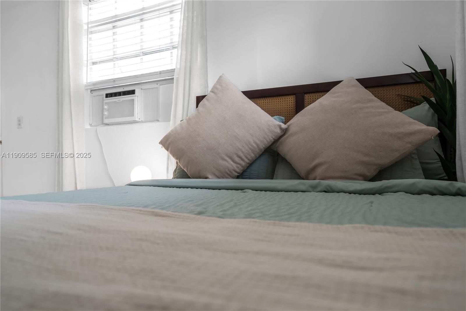 2972 Northwest 15th Street, Unit 2 Miami, FL 33125 - Photo 5 of 17 a view of a livingroom with wooden floor and a large window