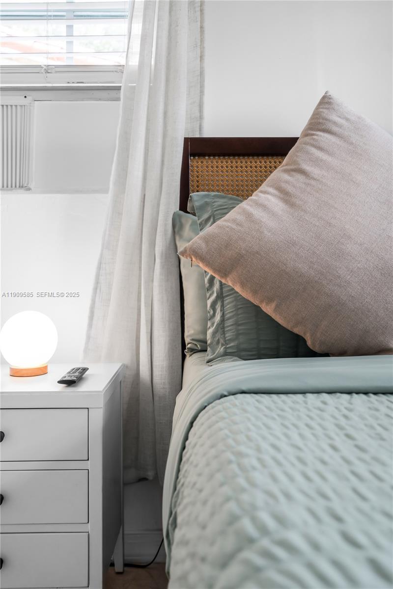 2972 Northwest 15th Street, Unit 2 Miami, FL 33125 - Photo 6 of 17 a view of staircase with railing and white walls