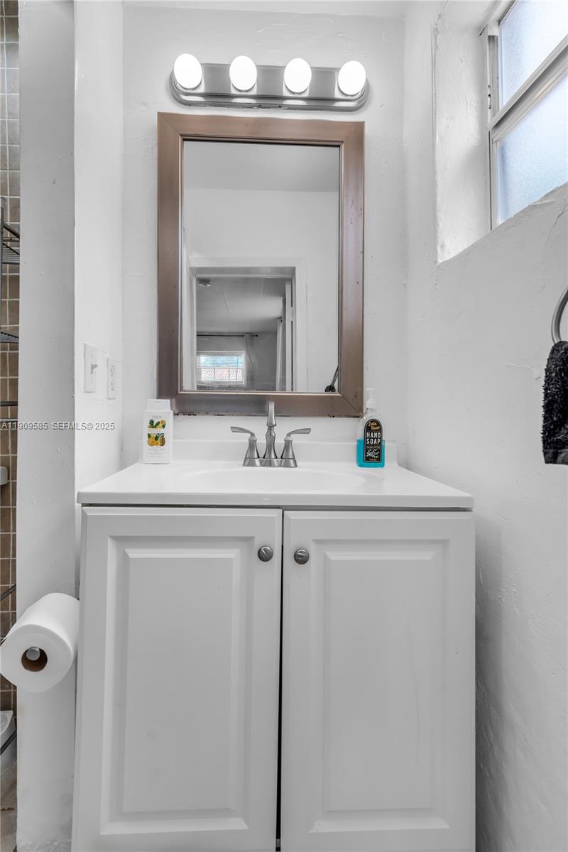 2972 Northwest 15th Street, Unit 2 Miami, FL 33125 - Photo 10 of 17 a bathroom with a sink vanity and a mirror