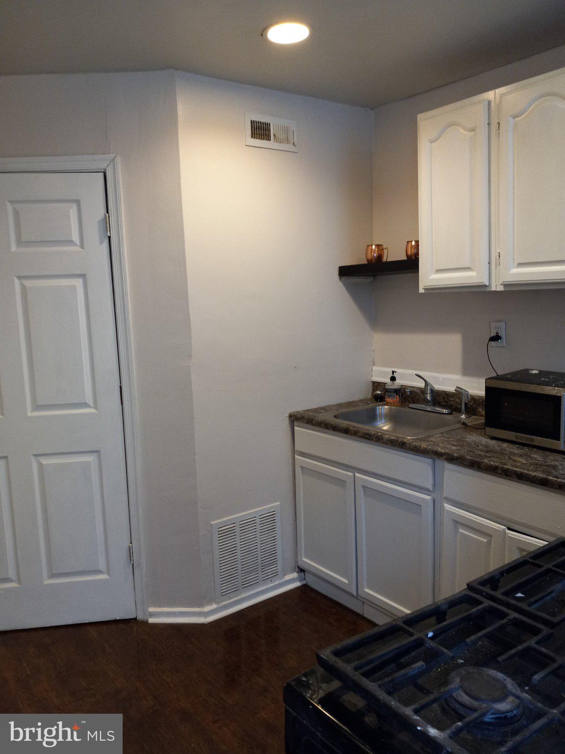 1406 5th Street Northwest Washington, DC 20001 - Photo 4 of 5 a kitchen with cabinets and a stove top oven