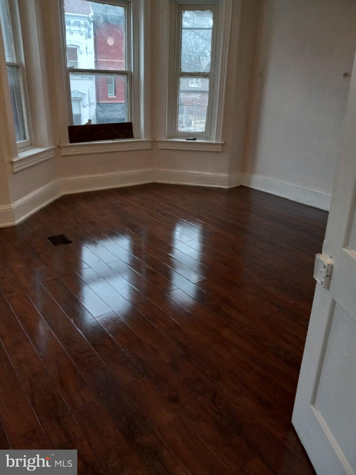 1406 5th Street Northwest Washington, DC 20001 - Photo 5 of 5 a view of an empty room with wooden floor and a window