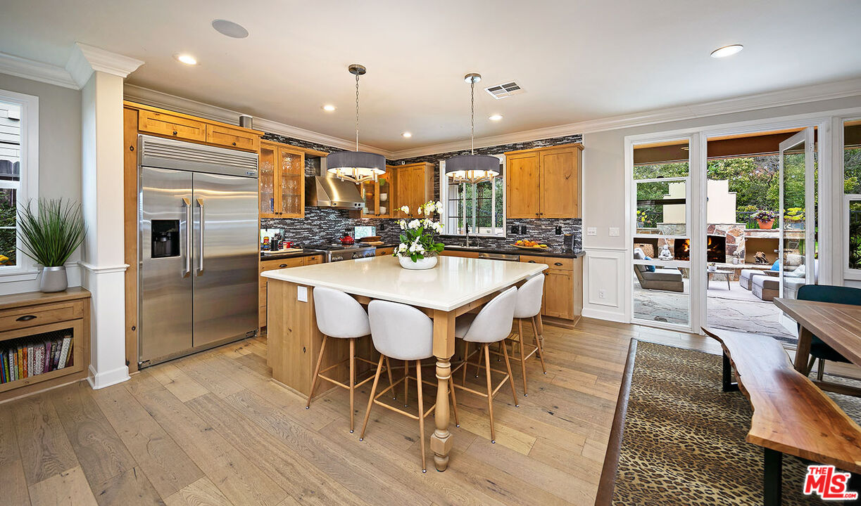 6372 Lagunitas Court Carpinteria, CA 93013 - Photo 7 of 19 a dining hall with stainless steel appliances kitchen island granite countertop a table chairs and a view of living room