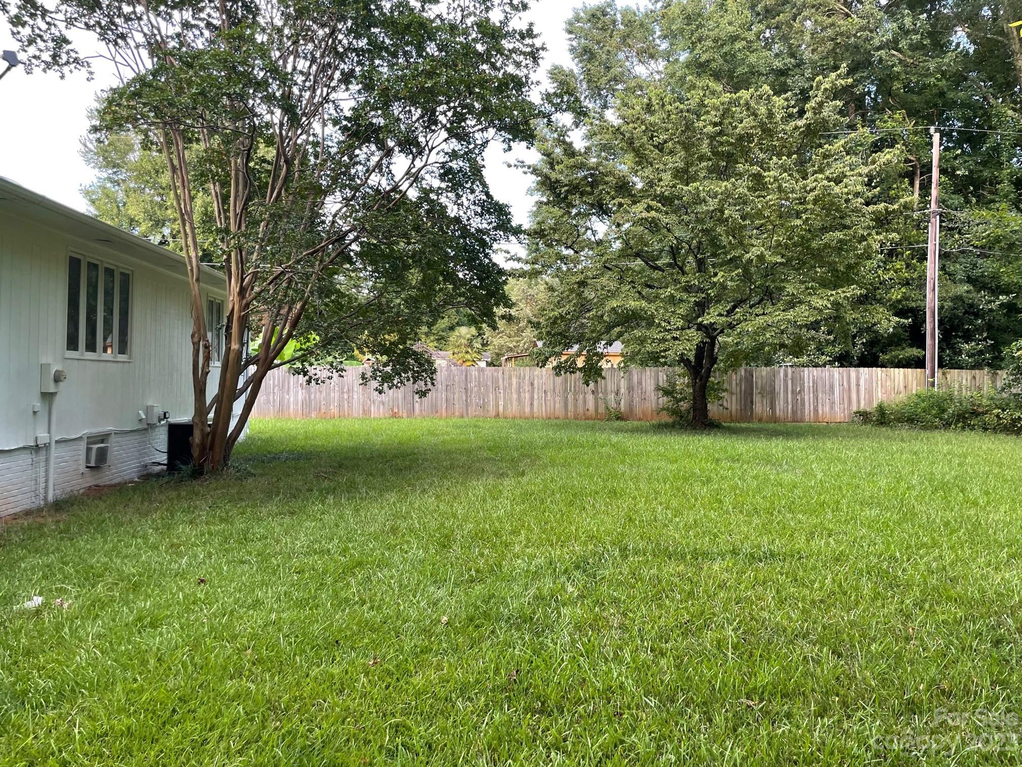 5700 Hickory Grove Road Charlotte, NC 28215 - Photo 7 of 7 a view of a yard with a house in the background