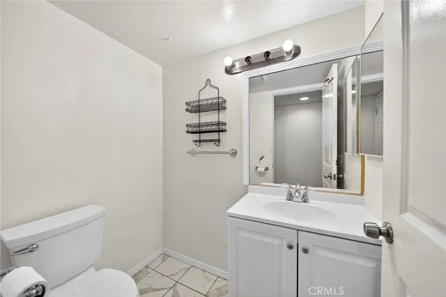 a bathroom with a sink mirror and toilet