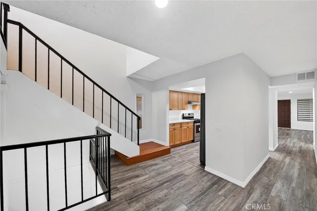 a view of staircase with wooden floor and a rug