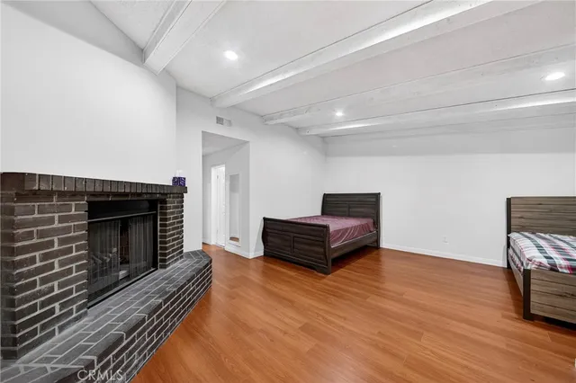 a living room with furniture a fireplace and wooden floor