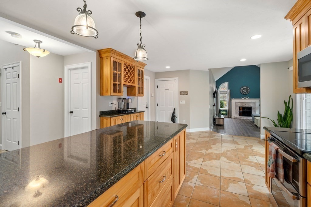 10 Brook Hill Road Sturbridge, MA 01518 - Photo 11 of 35 a kitchen with stainless steel appliances granite countertop a sink a stove and a wooden floors
