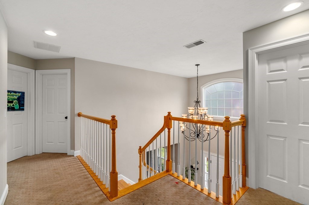 10 Brook Hill Road Sturbridge, MA 01518 - Photo 20 of 35 a view of a hallway with a chandelier